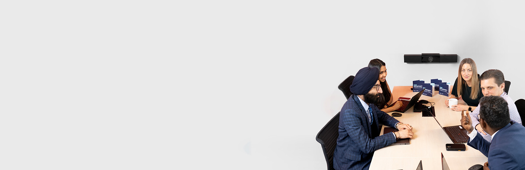 Invest Ontario team meeting in a meeting room. People sitting around a table.