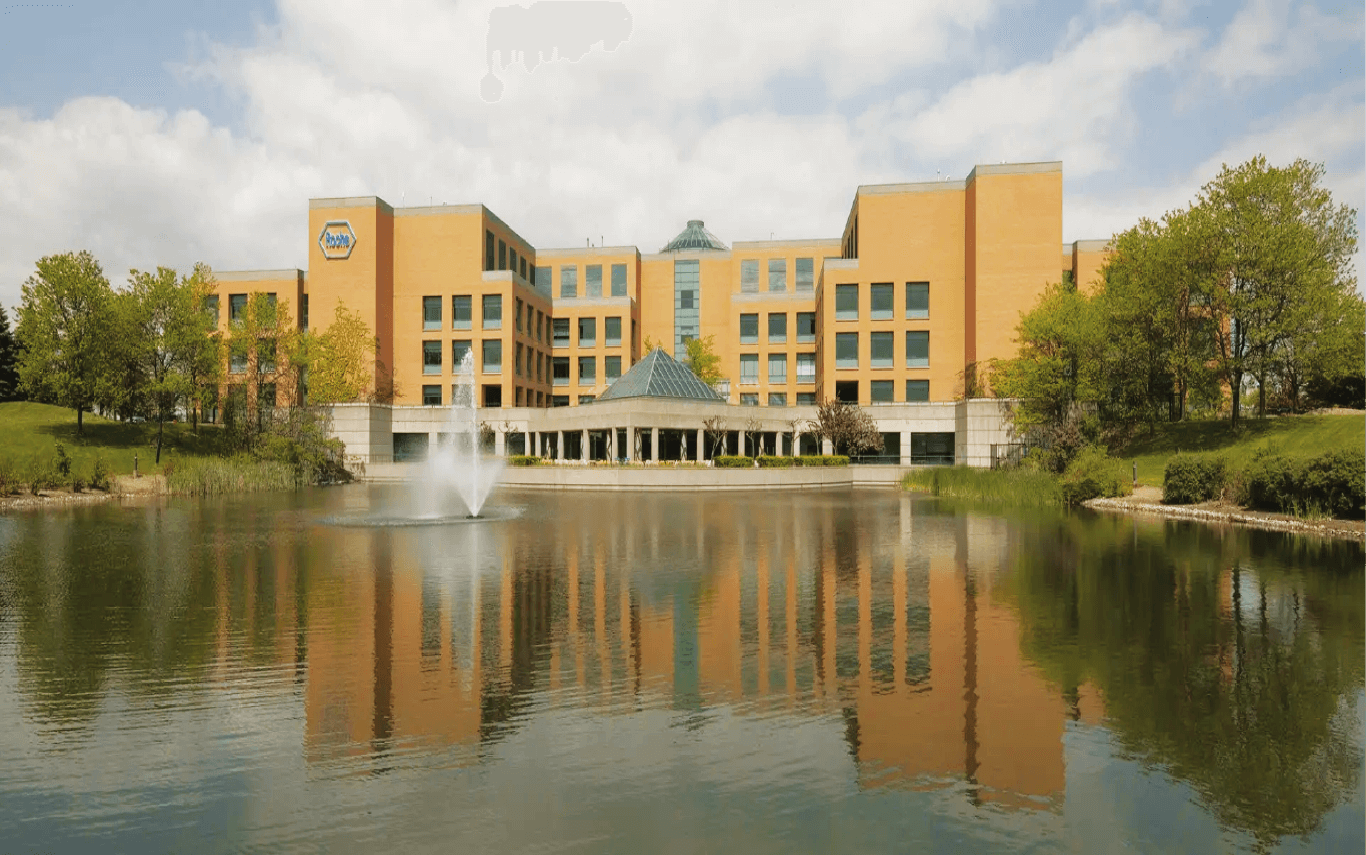 Roche building overlooking a lake.